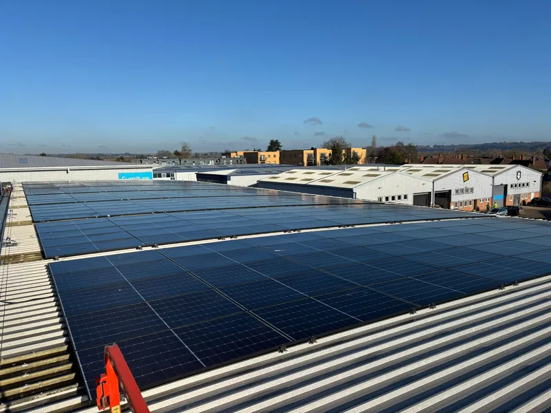 Large commercial solar array on industrial warehouse roof in Dorset