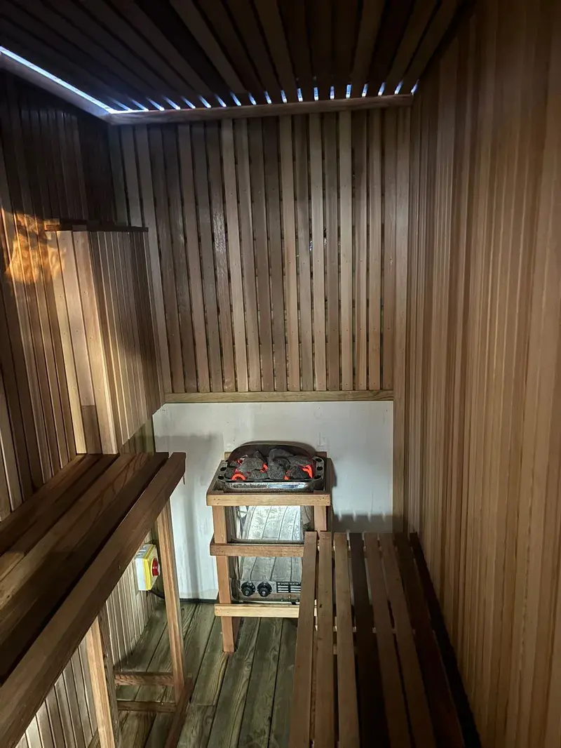 Sauna with LED strip lighting and electric heater wiring