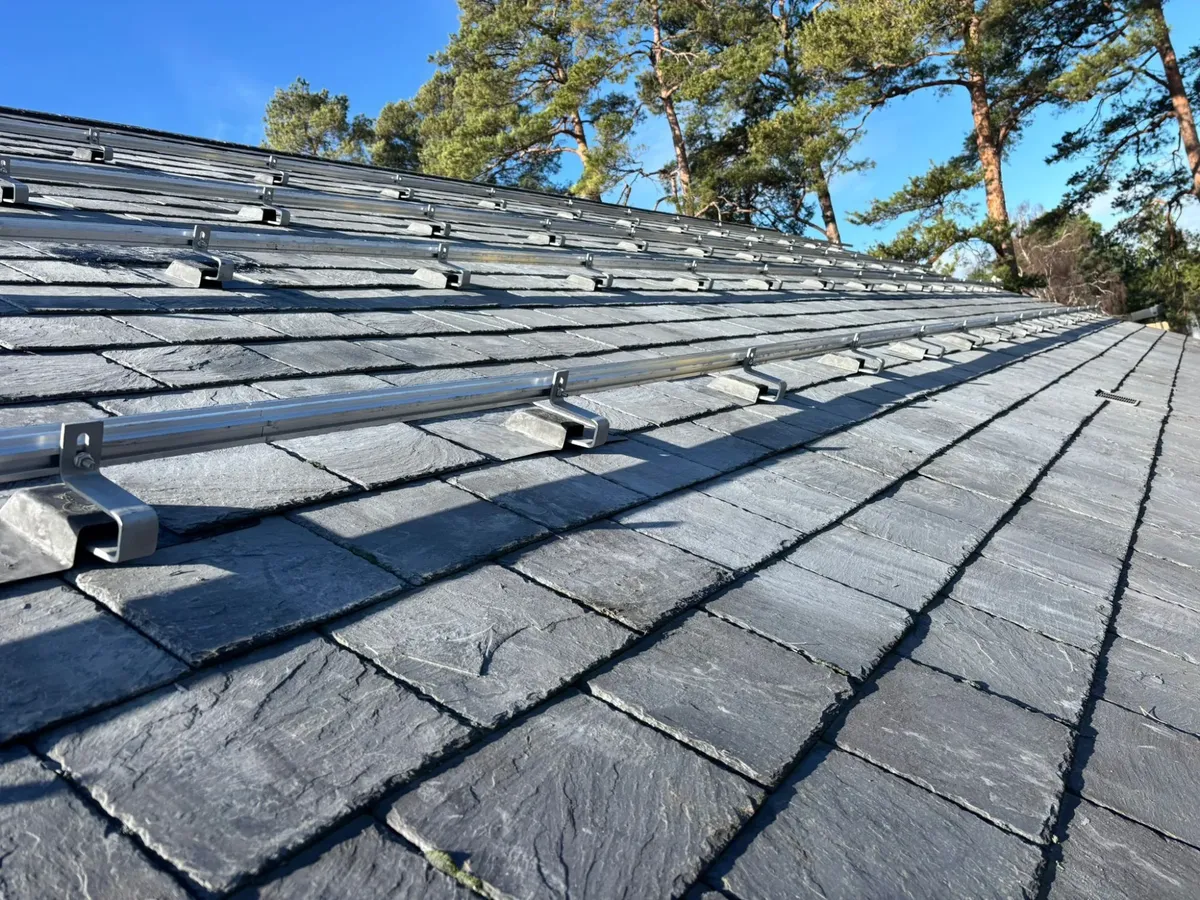 Mounting rails installed on natural slate roof ready for solar panels