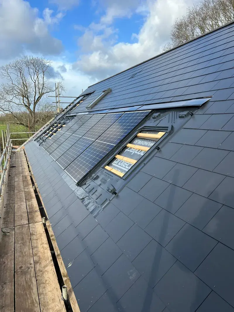 In-roof integrated solar panels on new-build slate roof with scaffolding